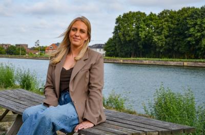 Foto Ellen Daems op een bank aan het water.